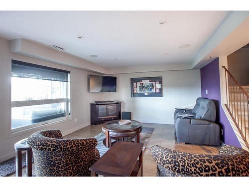 1120 High Country Drive Nw, High River, AB - Indoor Photo Showing Living Room With Fireplace