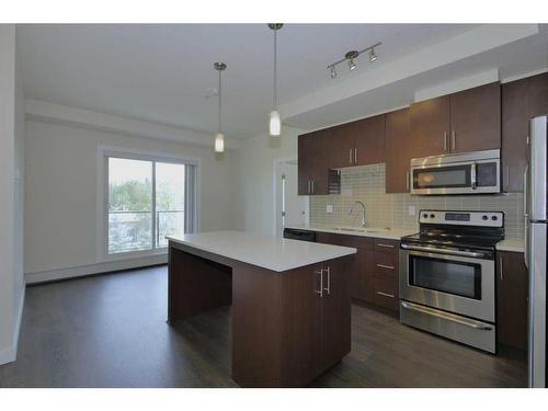 304-15233 1 Street Se, Calgary, AB - Indoor Photo Showing Kitchen With Upgraded Kitchen