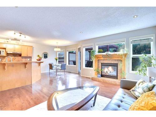 319 Springborough Way Sw, Calgary, AB - Indoor Photo Showing Living Room With Fireplace