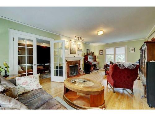 605 Macleod Trail Sw, High River, AB - Indoor Photo Showing Living Room With Fireplace