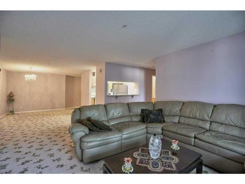 207-2022 Canyon Meadows Drive Se, Calgary, AB - Indoor Photo Showing Living Room