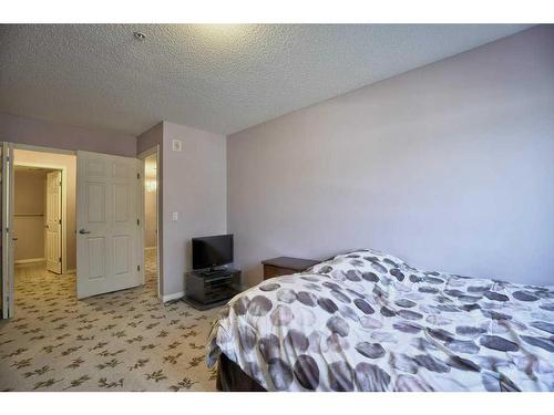 207-2022 Canyon Meadows Drive Se, Calgary, AB - Indoor Photo Showing Bedroom