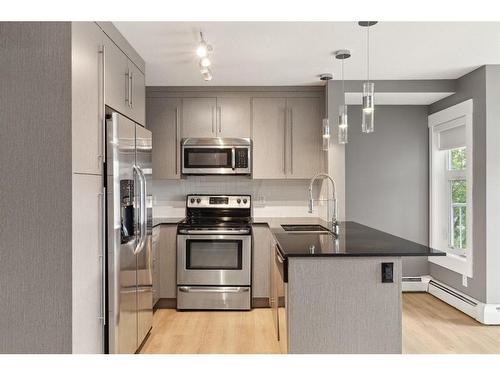 1210-11 Mahogany Row Se, Calgary, AB - Indoor Photo Showing Kitchen With Stainless Steel Kitchen With Double Sink With Upgraded Kitchen