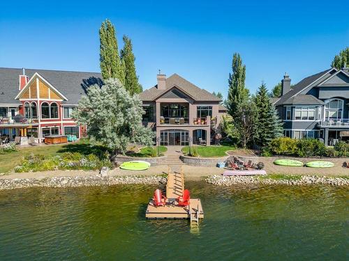 64 Heritage Lake Drive, Heritage Pointe, AB - Outdoor With Body Of Water With Deck Patio Veranda With Facade