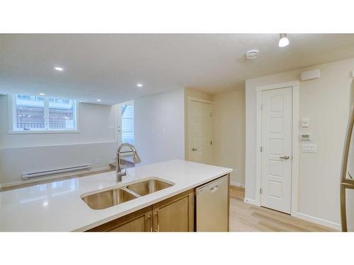 211-474 Seton Circle Se, Calgary, AB - Indoor Photo Showing Kitchen With Double Sink