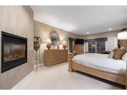 331 Diamond Willow Point, Rural Rocky View County, AB - Indoor Photo Showing Bedroom With Fireplace