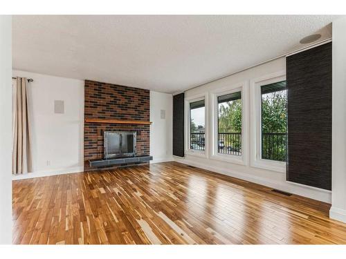 244 Queensland Road Se, Calgary, AB - Indoor Photo Showing Living Room With Fireplace