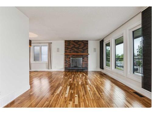 244 Queensland Road Se, Calgary, AB - Indoor Photo Showing Living Room With Fireplace