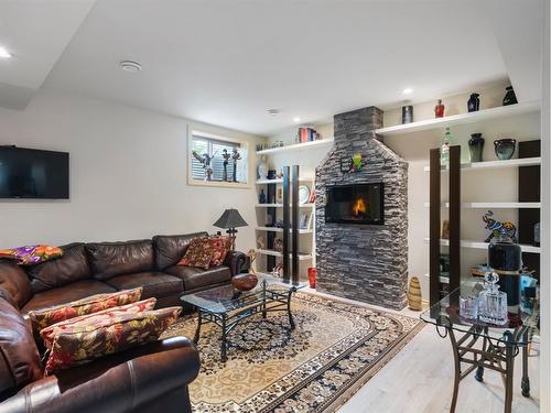 8990 9 Avenue Sw, Calgary, AB - Indoor Photo Showing Living Room With Fireplace