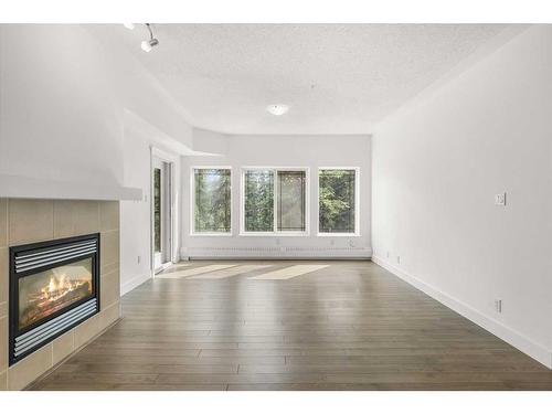 319-10 Discovery Ridge Close Sw, Calgary, AB - Indoor Photo Showing Living Room With Fireplace