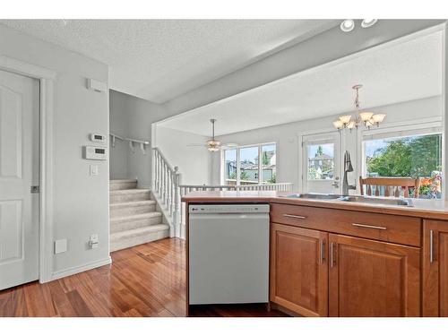 9 Crystal Shores Hill, Okotoks, AB - Indoor Photo Showing Kitchen With Double Sink