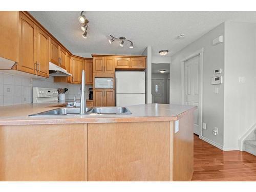 9 Crystal Shores Hill, Okotoks, AB - Indoor Photo Showing Kitchen With Double Sink