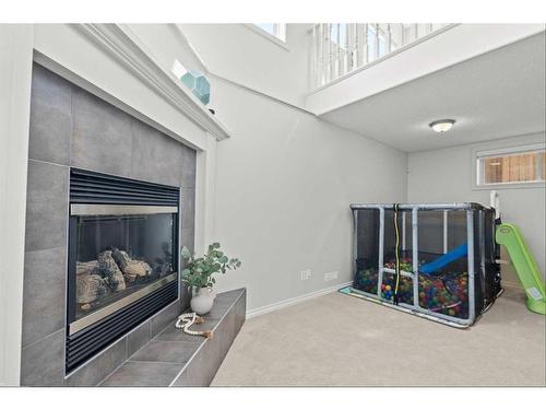 9 Crystal Shores Hill, Okotoks, AB - Indoor With Fireplace