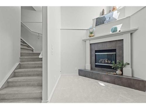 9 Crystal Shores Hill, Okotoks, AB - Indoor Photo Showing Living Room With Fireplace