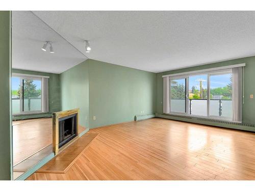 306-335 Garry Crescent Ne, Calgary, AB - Indoor With Fireplace