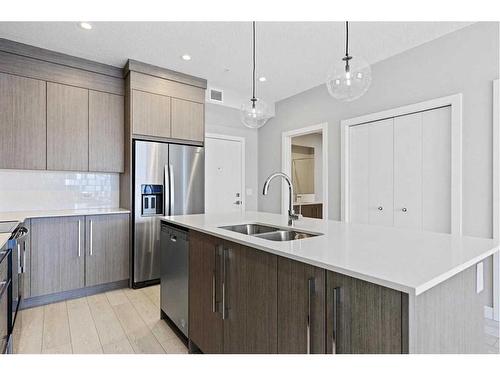 1402-681 Savanna Boulevard Ne, Calgary, AB - Indoor Photo Showing Kitchen With Stainless Steel Kitchen With Double Sink With Upgraded Kitchen