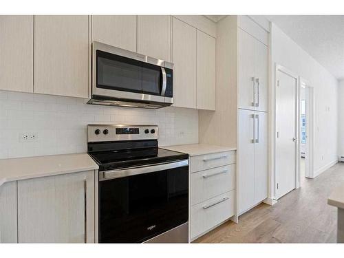 1402-681 Savanna Boulevard Ne, Calgary, AB - Indoor Photo Showing Kitchen