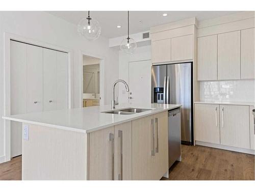 1402-681 Savanna Boulevard Ne, Calgary, AB - Indoor Photo Showing Kitchen With Stainless Steel Kitchen With Double Sink With Upgraded Kitchen