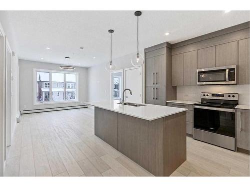 1402-681 Savanna Boulevard Ne, Calgary, AB - Indoor Photo Showing Kitchen With Stainless Steel Kitchen With Double Sink With Upgraded Kitchen