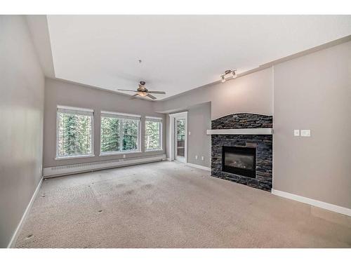 214-20 Discovery Ridge Close Sw, Calgary, AB - Indoor Photo Showing Other Room With Fireplace