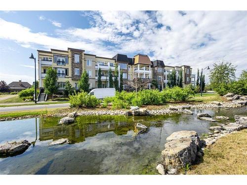 308-38 Quarry Gate Se, Calgary, AB - Outdoor With Body Of Water With View