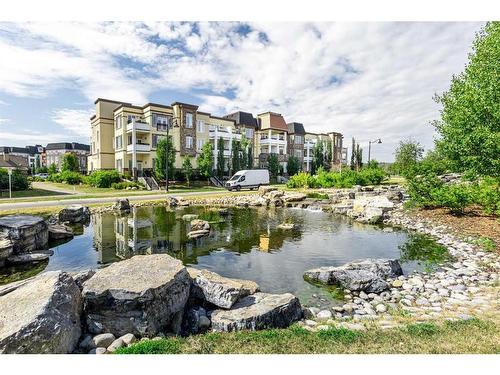 308-38 Quarry Gate Se, Calgary, AB - Outdoor With Body Of Water With View