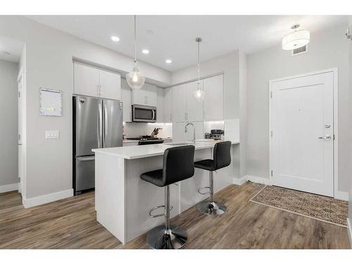 308-38 Quarry Gate Se, Calgary, AB - Indoor Photo Showing Kitchen With Upgraded Kitchen