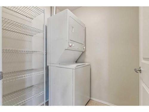 1203-928 Arbour Lake Road Nw, Calgary, AB - Indoor Photo Showing Laundry Room