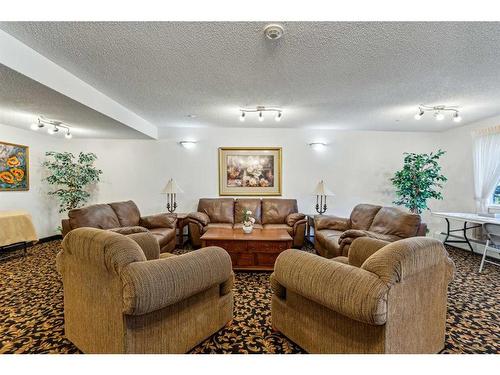 1203-928 Arbour Lake Road Nw, Calgary, AB - Indoor Photo Showing Living Room