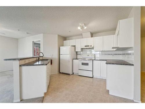 1203-928 Arbour Lake Road Nw, Calgary, AB - Indoor Photo Showing Kitchen