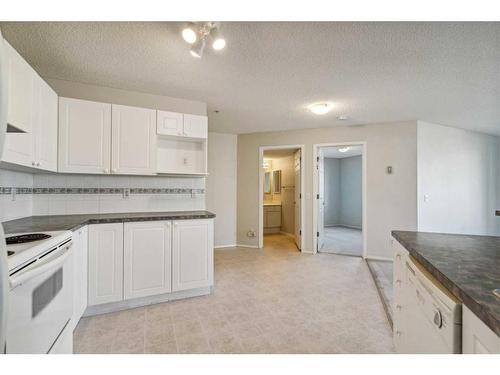 1203-928 Arbour Lake Road Nw, Calgary, AB - Indoor Photo Showing Kitchen