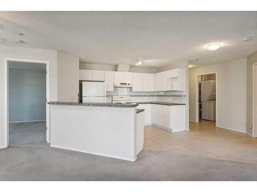 1203-928 Arbour Lake Road Nw, Calgary, AB - Indoor Photo Showing Kitchen