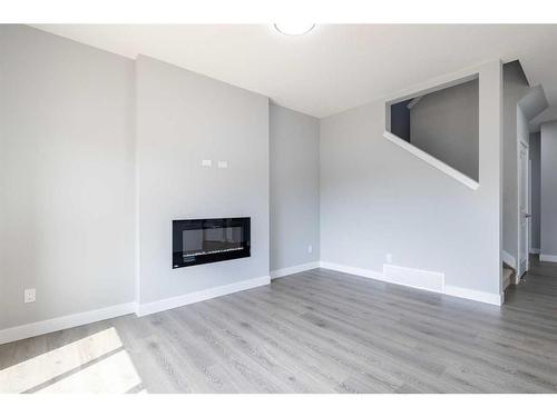 136 Sora Terrace Se, Calgary, AB - Indoor Photo Showing Living Room With Fireplace