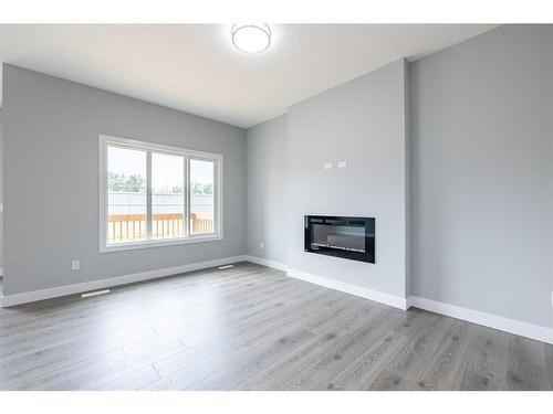 136 Sora Terrace Se, Calgary, AB - Indoor Photo Showing Living Room With Fireplace