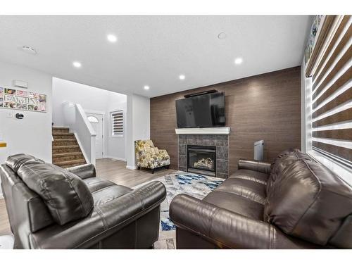 315 Saddlecreek Point Ne, Calgary, AB - Indoor Photo Showing Living Room With Fireplace