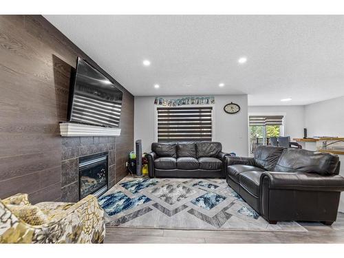 315 Saddlecreek Point Ne, Calgary, AB - Indoor Photo Showing Living Room With Fireplace