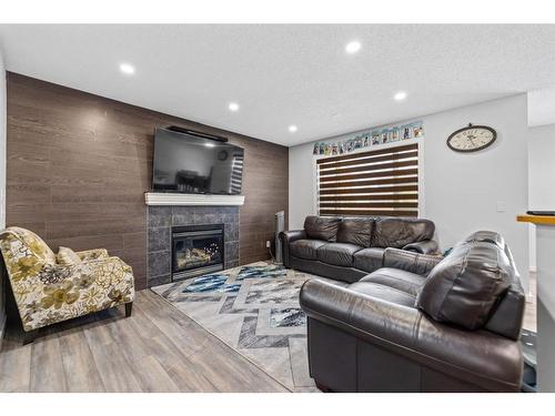 315 Saddlecreek Point Ne, Calgary, AB - Indoor Photo Showing Living Room With Fireplace