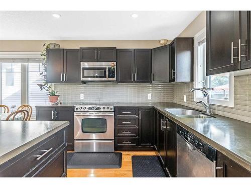 216 Windsor Avenue Nw, Diamond Valley, AB - Indoor Photo Showing Kitchen With Stainless Steel Kitchen With Double Sink With Upgraded Kitchen