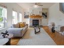 174 Prestwick Estate Way Se, Calgary, AB  - Indoor Photo Showing Living Room With Fireplace 