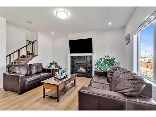 224 Dawson Harbour Heights, Chestermere, AB - Indoor Photo Showing Living Room With Fireplace