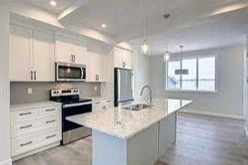 157 Cobblestone Gate Sw, Airdrie, AB - Indoor Photo Showing Kitchen With Stainless Steel Kitchen With Upgraded Kitchen