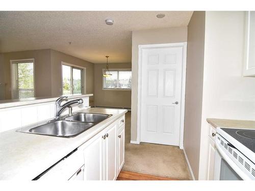 211-270 Shawville Way Se, Calgary, AB - Indoor Photo Showing Kitchen With Double Sink