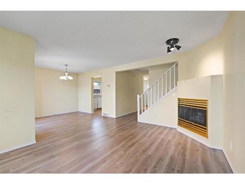 100-388 Sandarac Drive Nw, Calgary, AB - Indoor Photo Showing Other Room With Fireplace