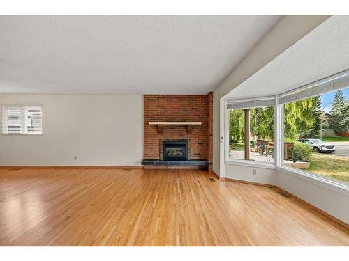 11408 Wilcox Street Se, Calgary, AB - Indoor Photo Showing Living Room With Fireplace