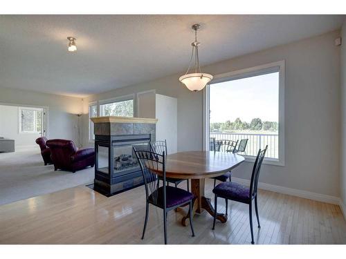 242132 88 Street East, Rural Foothills County, AB - Indoor Photo Showing Dining Room With Fireplace