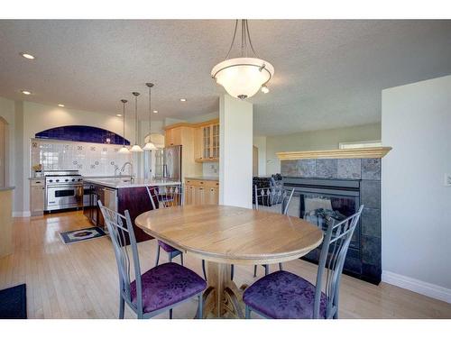 242132 88 Street East, Rural Foothills County, AB - Indoor Photo Showing Dining Room With Fireplace