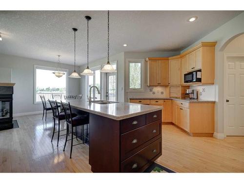 242132 88 Street East, Rural Foothills County, AB - Indoor Photo Showing Kitchen With Fireplace