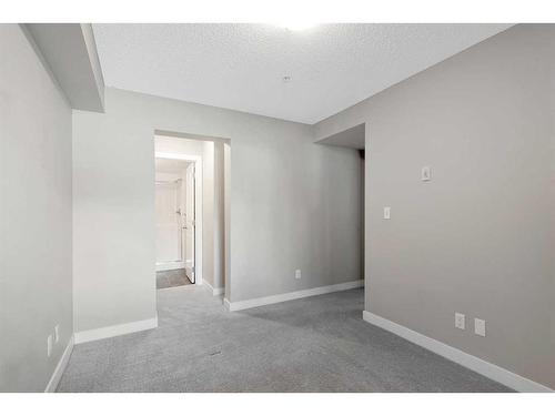 9110-403 Mackenzie Way Sw, Airdrie, AB - Indoor Photo Showing Other Room