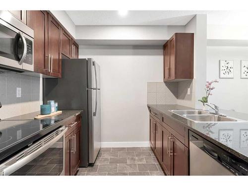 9110-403 Mackenzie Way Sw, Airdrie, AB - Indoor Photo Showing Kitchen With Double Sink