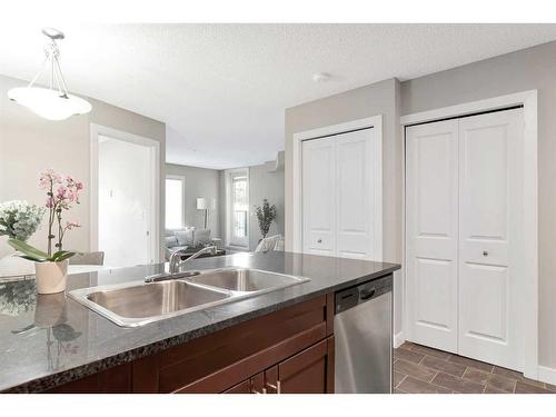 9110-403 Mackenzie Way Sw, Airdrie, AB - Indoor Photo Showing Kitchen With Double Sink